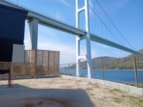 a view of a bridge over a body of water at nagi-setouchi in Kure