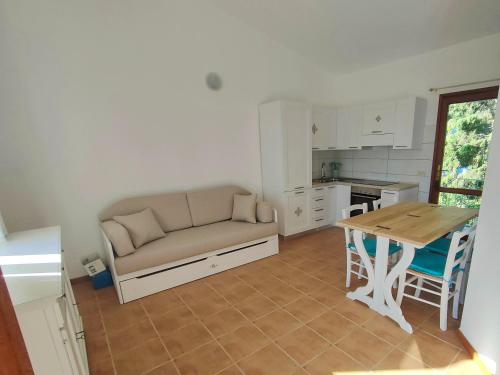ein Wohnzimmer mit Sofa und Tisch in der Unterkunft La Terrazza sul Mare in San Teodoro