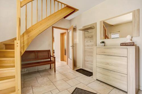 einen Flur mit einer Treppe und einen Schrank mit einer Bank in der Unterkunft Die Spreewaldbetten - Bauernhof in Schmogrow