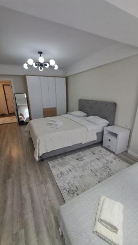 a large bedroom with two beds and a rug at AIRPORT&APARTMENT&parking in Chişinău