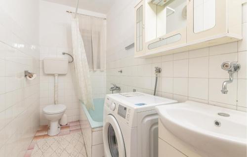biała łazienka z pralką i umywalką w obiekcie Cozy Apartment In Senj With Wifi w mieście Senj