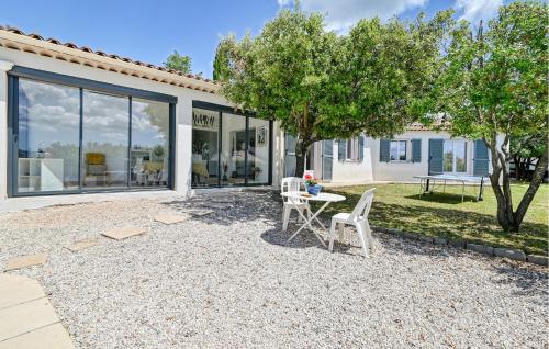 a patio with a table and chairs in front of a house at 3 Bedroom Lovely Home In Tourves in Tourves