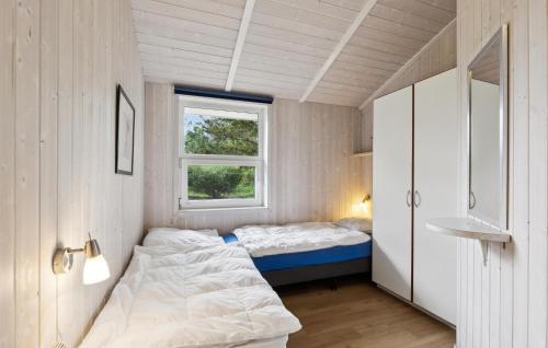 a small bedroom with a bed and a window at Strandblick 13 - Dorf 1 in Travemünde