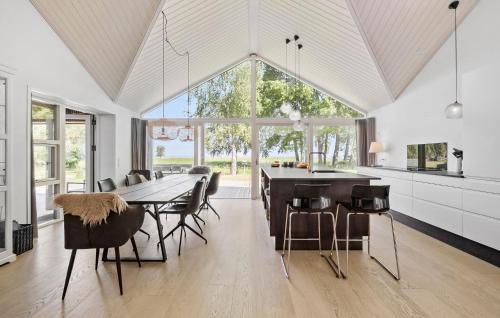 a kitchen and dining room with a table and chairs at 4 Bedroom Nice Home In Strøby in Strøby