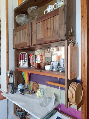 a shelf with dishes and utensils in a kitchen at Kokkooning in Kokóni