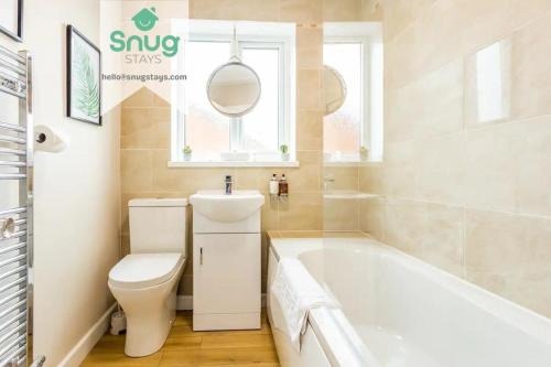 a bathroom with a tub and a toilet and a sink at Hardwick House 3 bed with parking for Contractors & Tourists in Gateshead