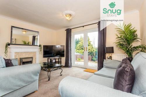 a living room with two couches and a fireplace at Hardwick House 3 bed with parking for Contractors & Tourists in Gateshead