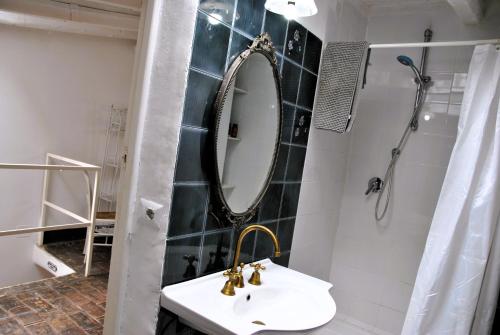 a bathroom with a sink and a mirror at Il giardino dei limoni casa nel Borgo in Maranola
