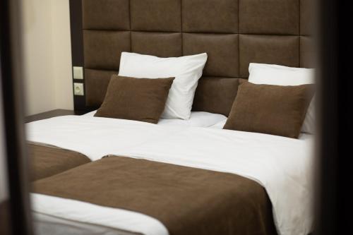 two beds in a hotel room with pillows at BLH in Yerevan