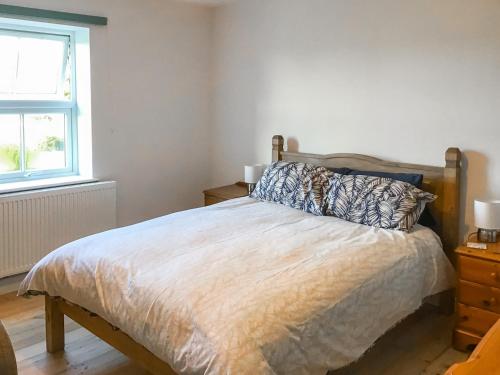 a bedroom with a bed and a window at Hempstead End in Lessingham