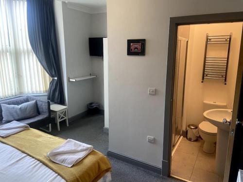 a hotel room with a bed and a bathroom at Ivy Mount Boutique in Manchester