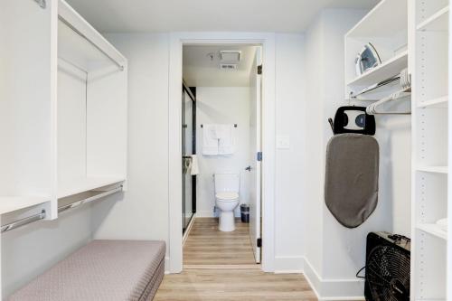 a small bathroom with a toilet and a hallway at 2BR Executive Apartment in Prime Location in Arlington