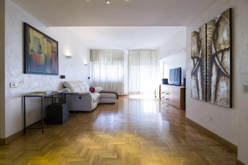 a living room with a couch and a table at FieraMilano 3BR Apartment in Milan
