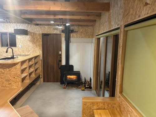 a living room with a wood stove in a room at nagi-setouchi in Kure