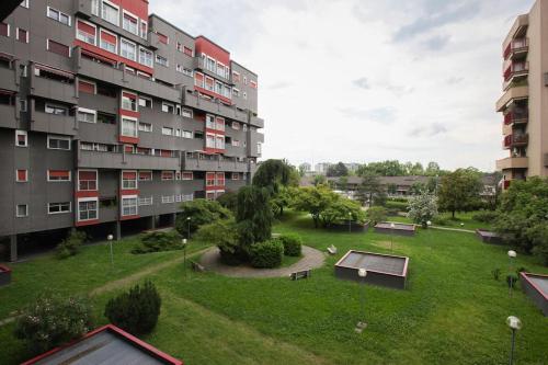 an apartment complex with a park in front of it at FieraMilano 3BR Apartment in Milan