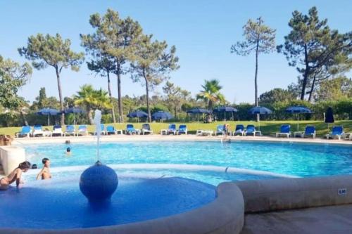 a pool at a resort with people playing in it at Victory Village Club,Quinta do Lago in Loulé