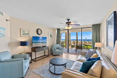 a living room with a couch and a tv at Bluewater Unit 104 in Orange Beach