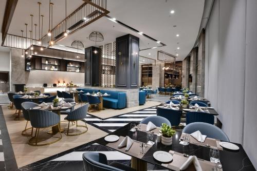 a restaurant with tables and chairs and a bar at The Fern Residency, Gandhinagar in Gandhinagar