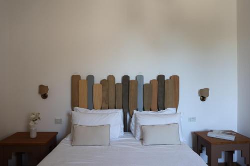 a bedroom with a bed with a wooden headboard at Villa Puolo - With Private Sea Access in Sorrento