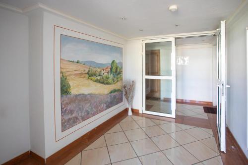 a room with a large painting on the wall at A13 - 1 BDR Garden floor Fontonne - AC, Pool & Parking in Antibes