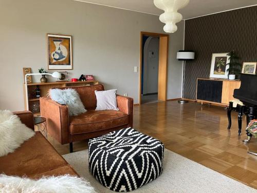 a living room with a couch and a chair at Großzügige Wohnung mit Flair und Aussicht in Bad Bergzabern