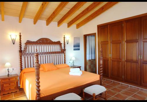 ソン・カリオにあるFinca Sa Torre Novaのベッドルーム(オレンジ色のベッド1台、木製キャビネット付)