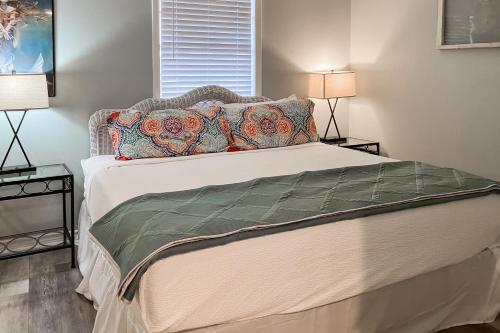 a bedroom with a large bed with two lamps at A Pirate's Place in Rockport