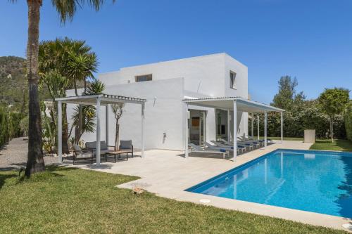 a villa with a swimming pool in front of a house at Villa Marc II in Sant Jordi