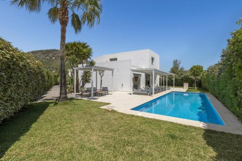 a white house with a swimming pool in the yard at Villa Marc II in Sant Jordi