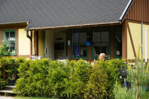 a man standing in front of a house at Ystad Holiday Houses in Ystad