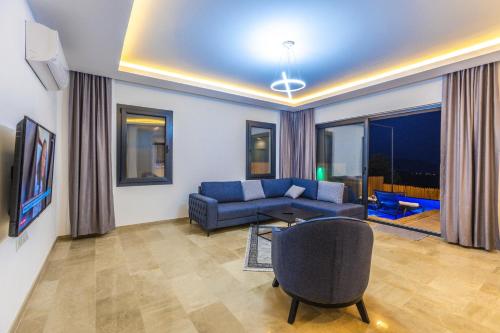 a living room with a blue couch and a chair at Albedo Villa in Kas