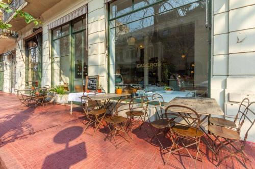 a patio with tables and chairs in front of a building at Premium Apt 2BR 24x7 San Telmo 300 Mb La Galerie in Buenos Aires