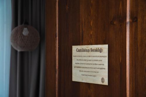 a wooden door with a sign on it at Casa Alegre Alaçatı in Alacati