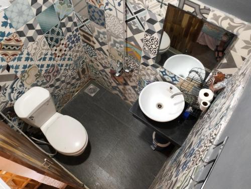 a bathroom with two sinks and two mirrors at BONNIE HOMESTAY Mui Ne in Mui Ne
