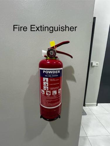 a fire extinguisher on the side of a wall at Matsurika Guest House - Kulim in Kulim