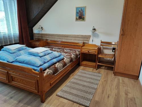 a bedroom with a bed with blue pillows on it at Ferienhaus in Zebegény mit Garten und Grill in Zebegény