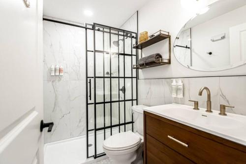 a bathroom with a toilet and a sink and a mirror at Historic Downtown Studio, Steps to Bathhouse Row, Room # 203 in Hot Springs