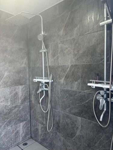 a bathroom with a shower with a shower head at nagi-setouchi in Kure
