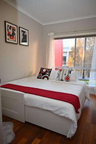 a bedroom with a large white bed with a window at Mawson Red - Free Pool access -Onsite Parking-Netflix-5 mins to Mawson Interchange in Mawson Lakes