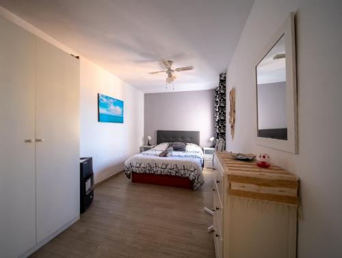a bedroom with a bed and a dresser in it at terraza al mar in Pineda de Mar