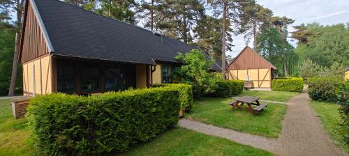 a small house with a bench in the yard at Ystad Holiday Houses in Ystad