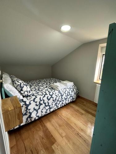 a bedroom with a bed in a attic at El polvorín in El Franco