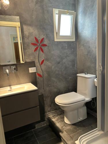 a bathroom with a toilet and a sink at La Meridiana in Augusta