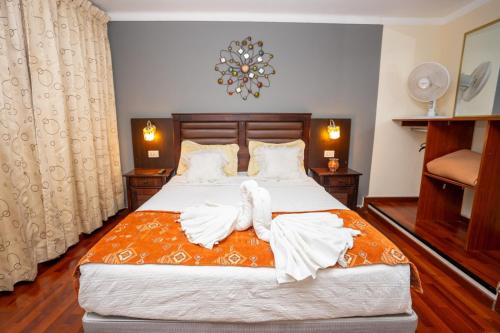 a bedroom with a bed with towels on it at GOLD INFINITY in Tacna