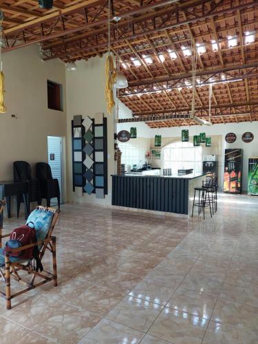 a room with a chair in the middle of a room at Chácara Goufran in Caçapava