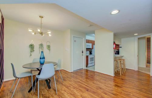 a dining room and living room with a table and chairs at 3 Bedrooms Spacious Central Condo w Pool in Houston