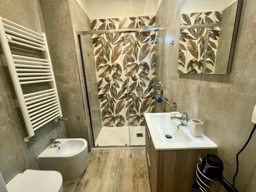 a bathroom with a shower and a sink and a toilet at Le Dimore di Lorenzo in Naples