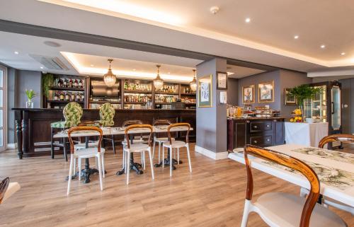 a dining room and kitchen with a table and chairs at Romney Park Luxury Apartments by The Stay Collection in Cape Town