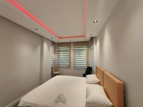 a bedroom with a large white bed and a window at Sunny Antalya VILLA in kale içi Antalya 7 persoons in Antalya