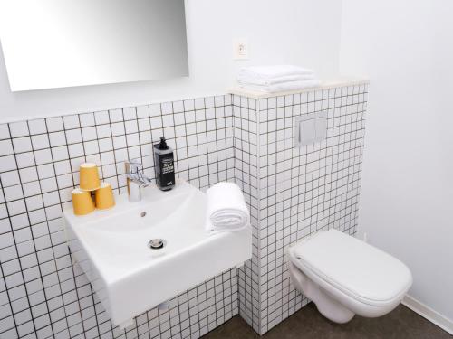 a white bathroom with a sink and a toilet at ibis budget Toulouse Colomiers in Colomiers